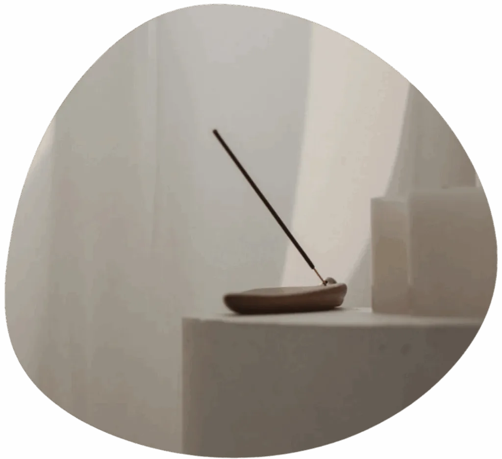 Home 1 incense stick placed in a holder on a white table
